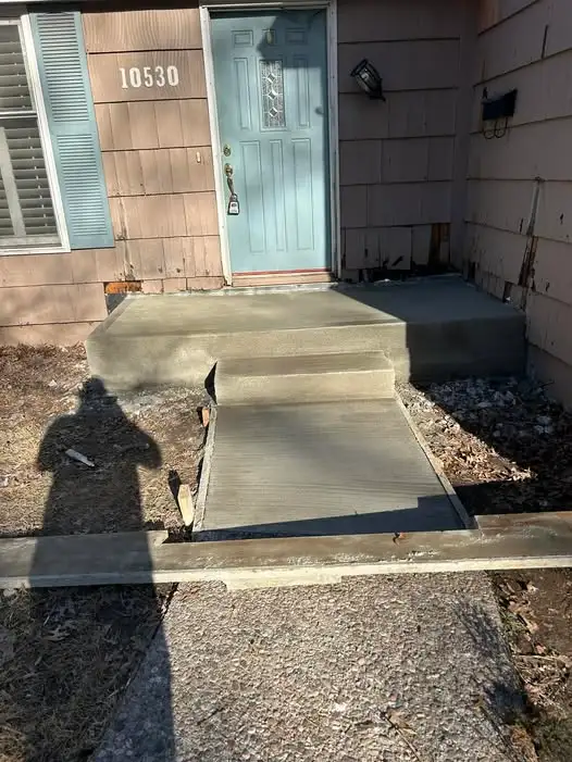 newly poured concrete steps and walkway leading to a front door of a house