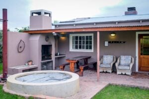 Concrete patio hot tub installation in a backyard with comfortable outdoor seating