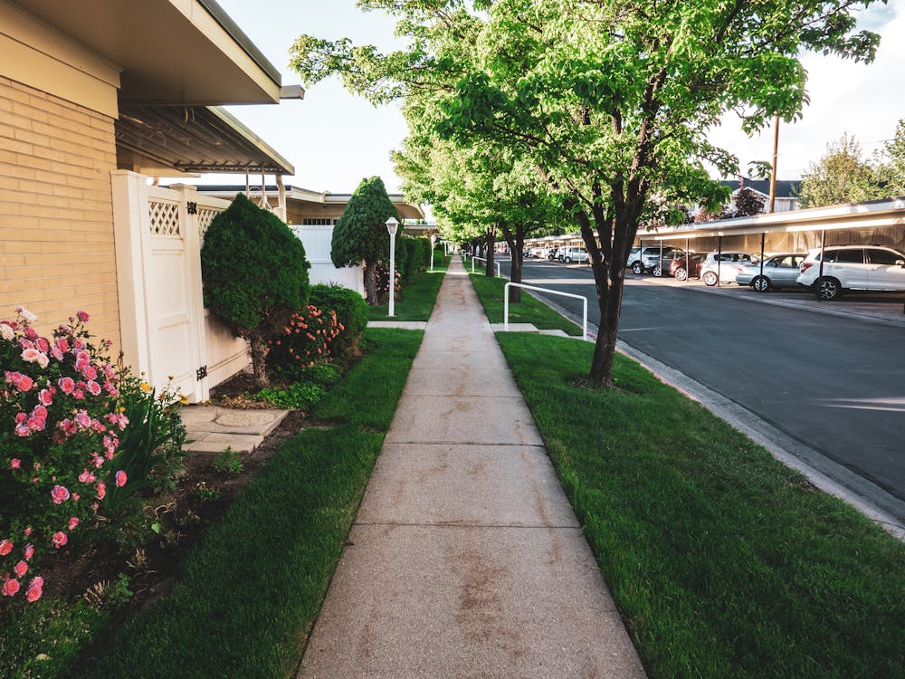 Smooth concrete sidewalk in a residential neighborhood with curb detail