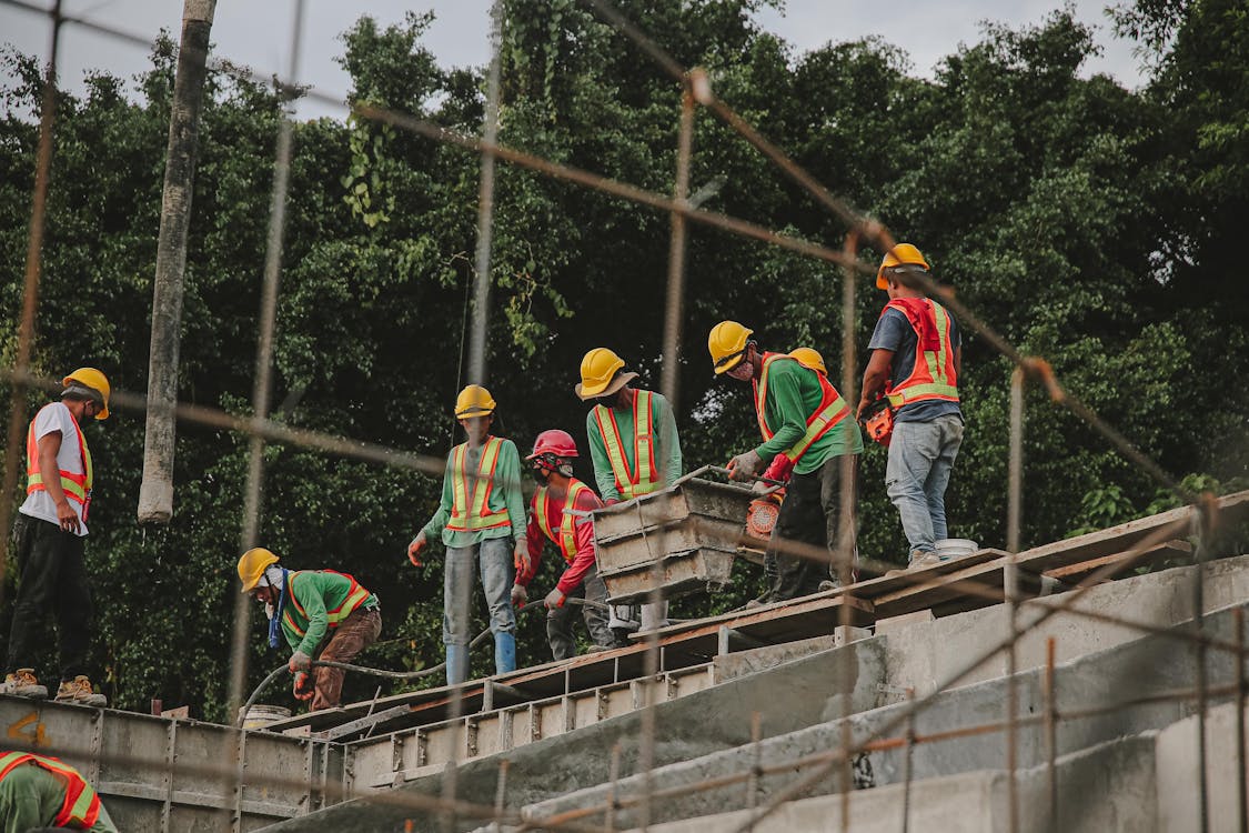 Construction crew wearing hard hats working together on a building project