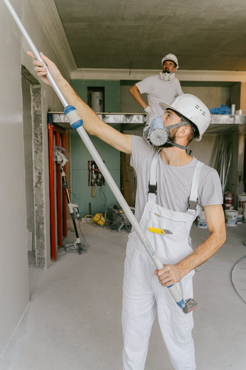 Construction workers renovating residential home exterior with quality materials