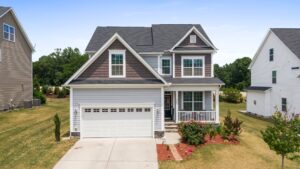 Durable concrete driveway leading to a residential garage showing quality finish