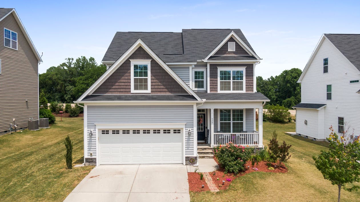 Durable concrete driveway leading to a residential garage showing quality finish
