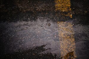 Wet concrete surface showing the effects of pouring concrete in rain on a residential project