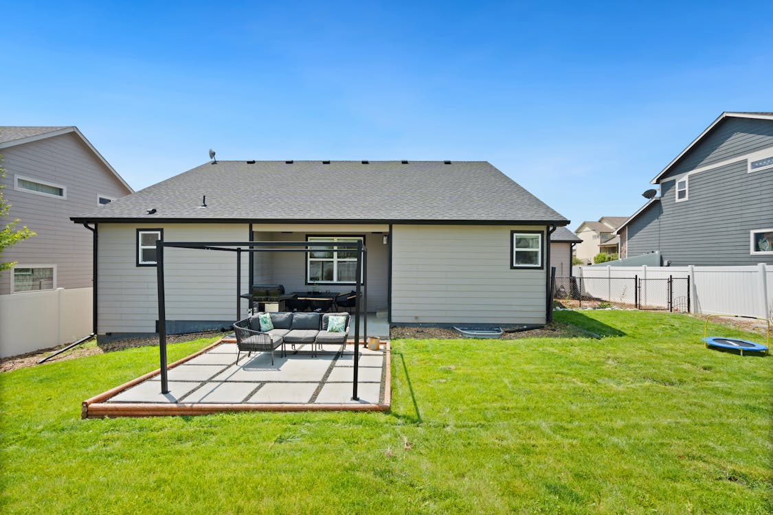 Residential backyard patio with smooth concrete surface built for durability