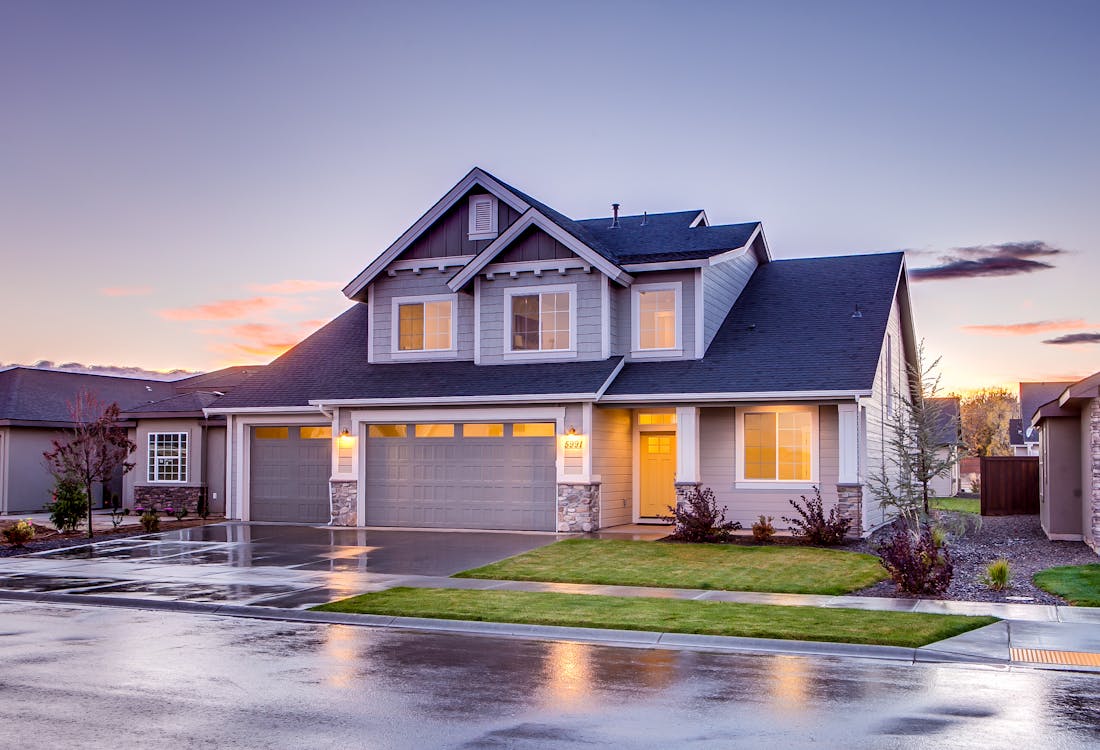 Suburban home with well-maintained concrete driveway at twilight