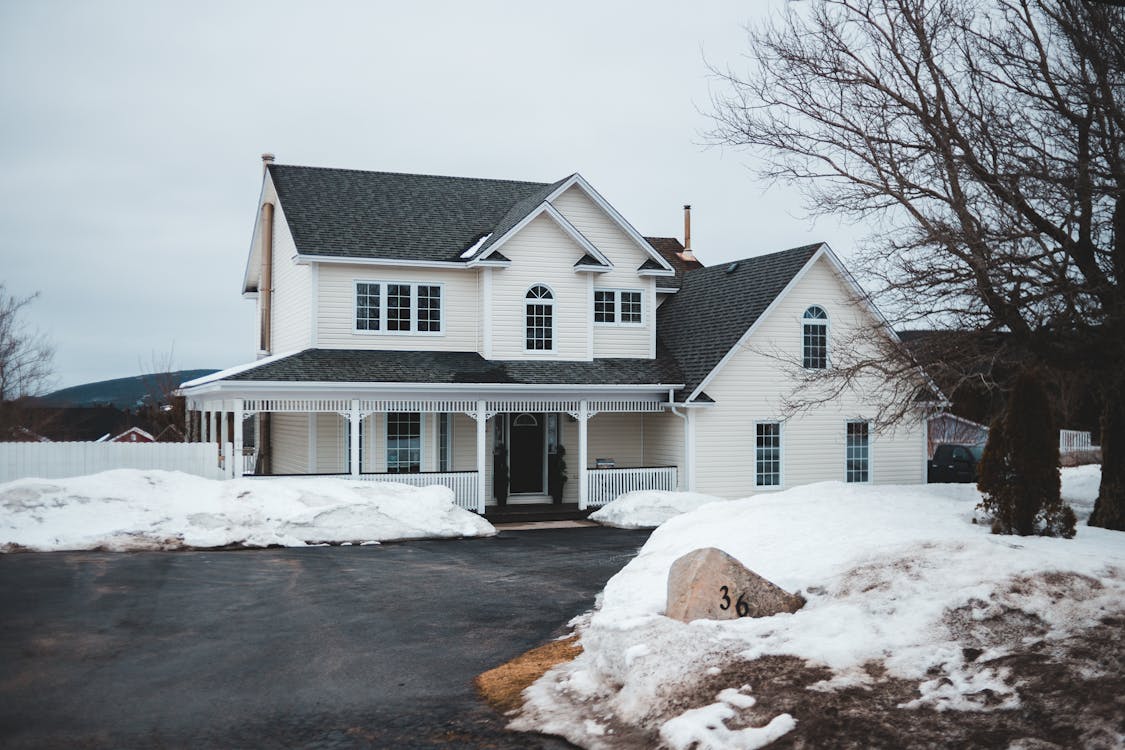 Suburban house during winter showing freeze-thaw conditions that affect driveways