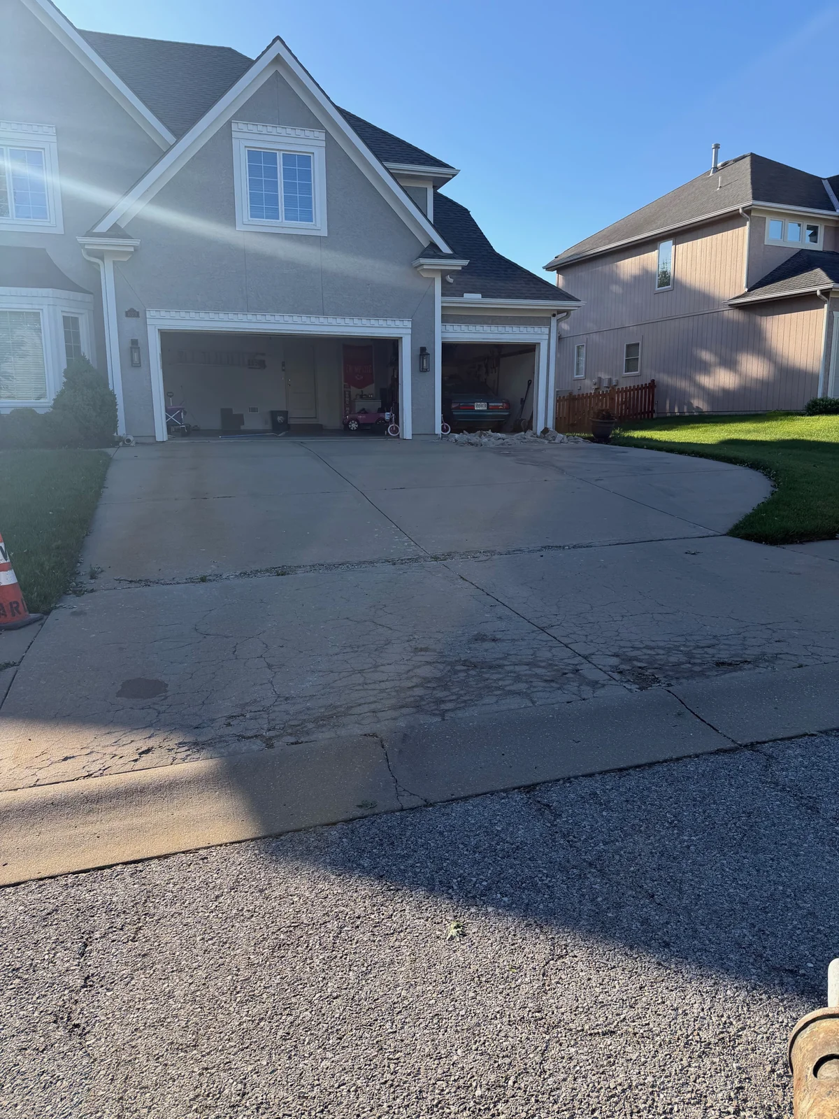 D-cracking concrete driveway showing crescent-shaped hairline cracks and surface deterioration